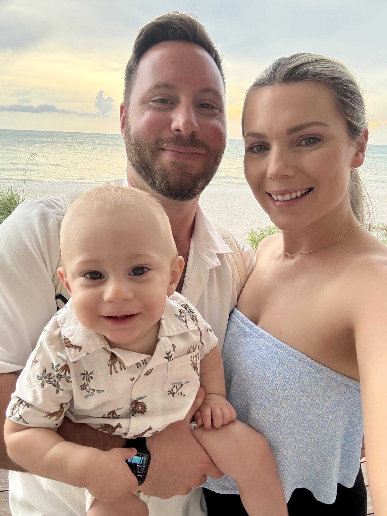 Austin, Sarah, and Lincoln Frangoules on the beach at sunset