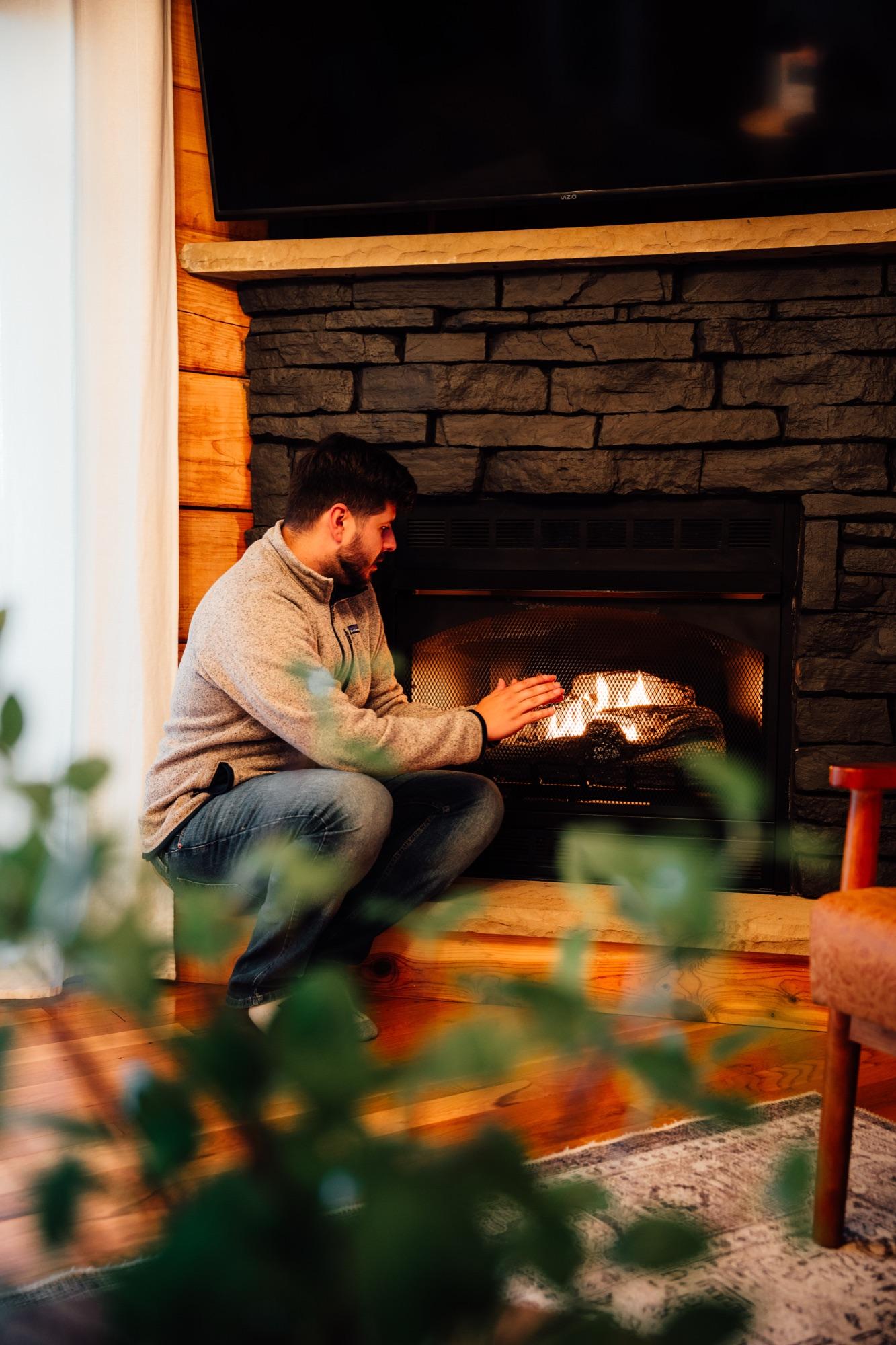 A fireplace lit in a Wander Luxe living room before a stay