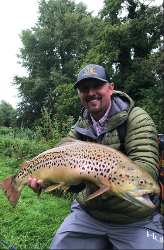 Curtis Fleming of Fly Rod Chronicles holding a brown trout