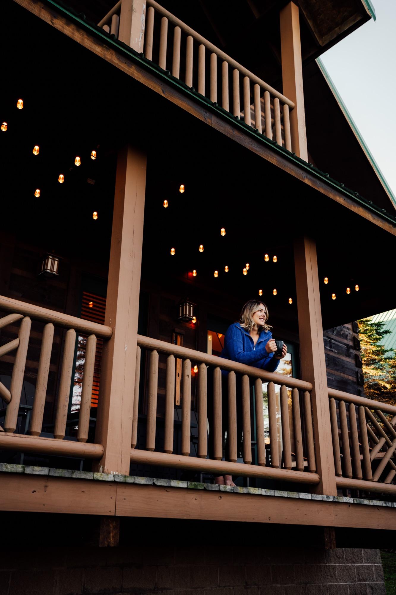 Sarah on a Wander Luxe porch under string lights at dusk