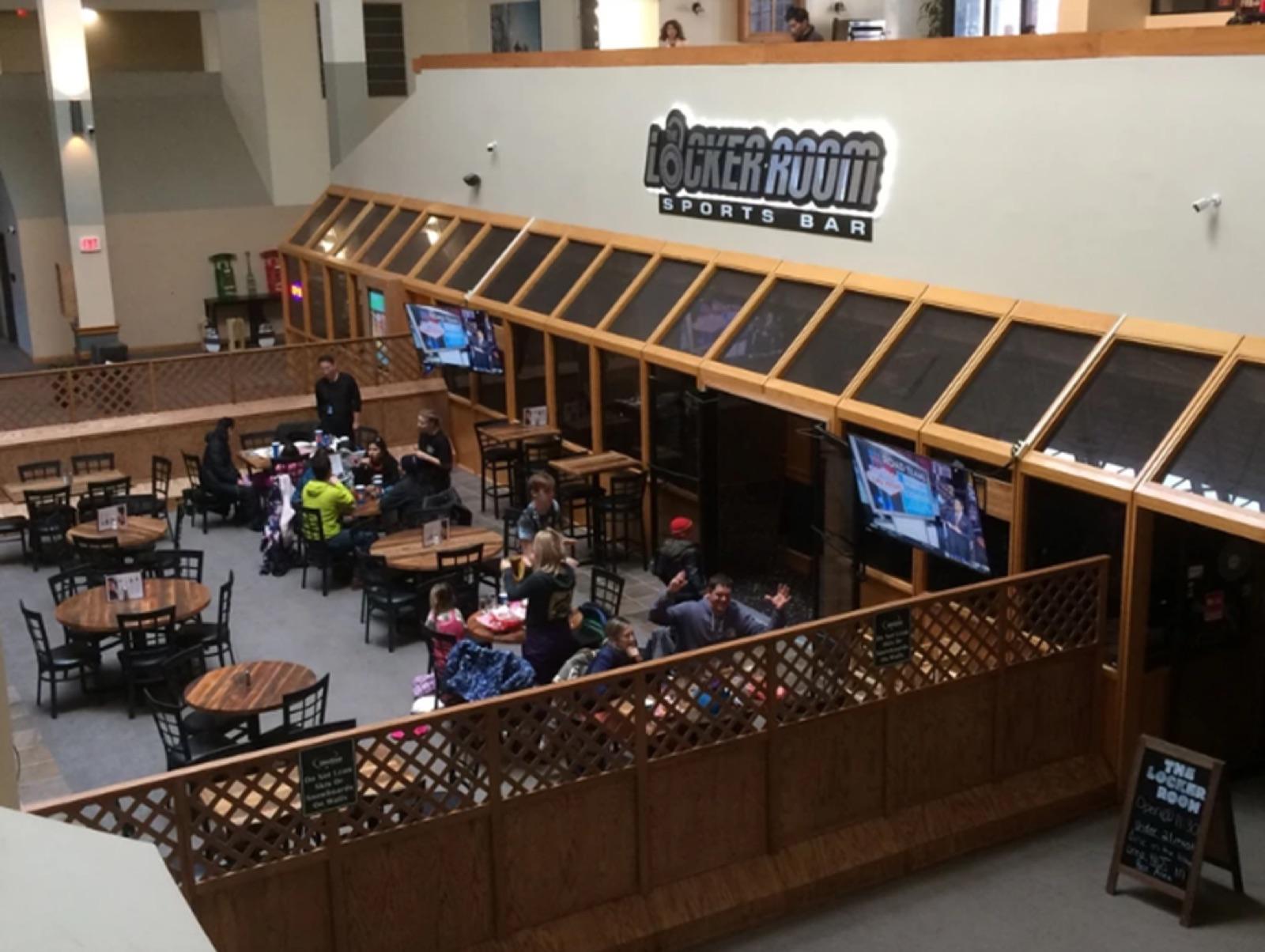 The Locker Room Sports Bar dining room inside Silver Creek Lodge with tables and TVs