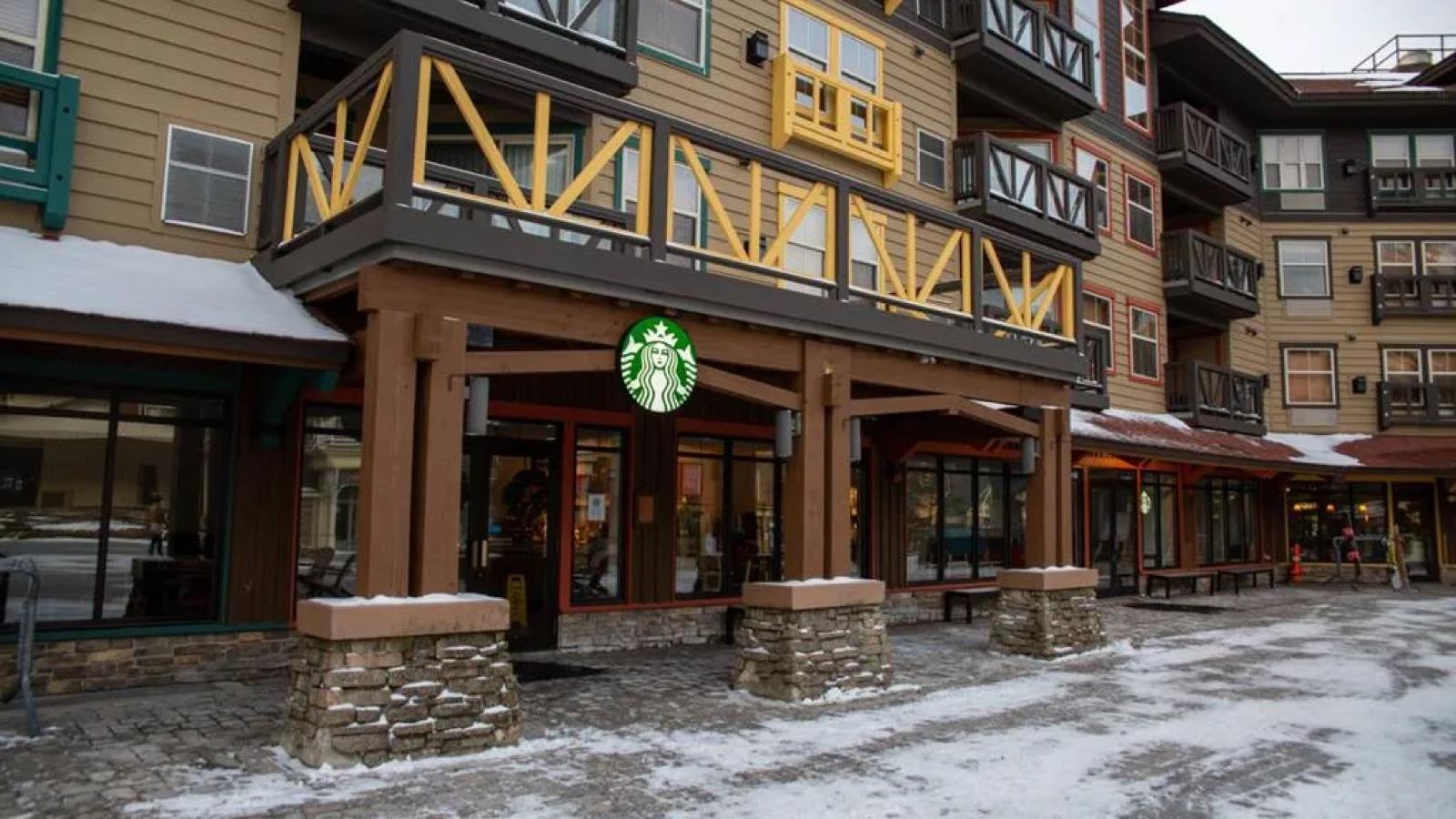 The Starbucks storefront under the timber balcony on the Village walkway in winter