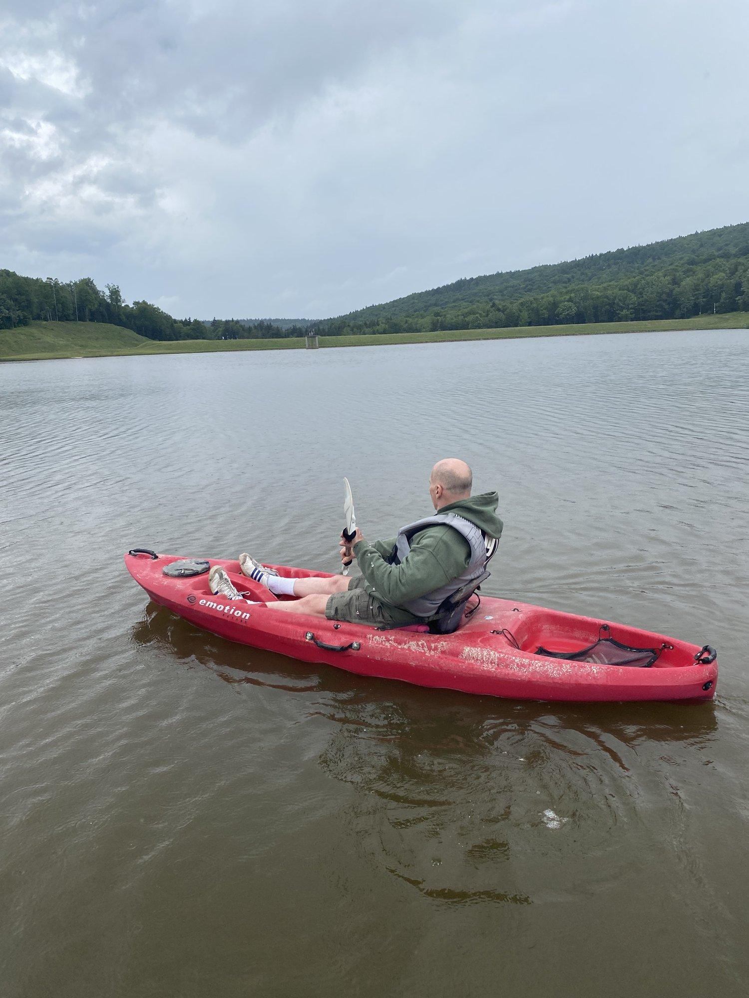 A red kayak on the calm water of Shavers Lake